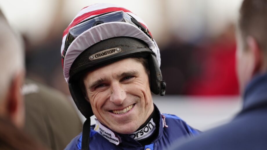 Image shows a photo of Harry Skelton, smiling in the paddock at Sandown in December 2025.