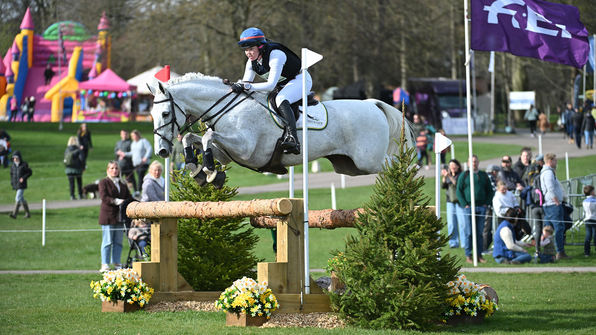 Meghan Healy and Think It Over jump a fence on the intermediate level eventing cross-country course at Thoresby.