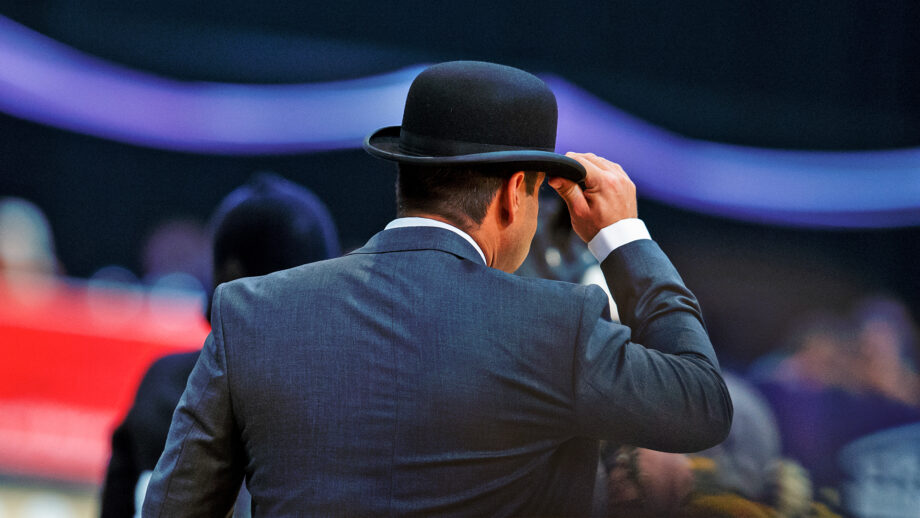 A HOYS judge from behind wearing a bowler hat and a smart suit.