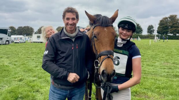 Tabitha Taylor, mother Amanda and father Jeremy, with a horse at an event