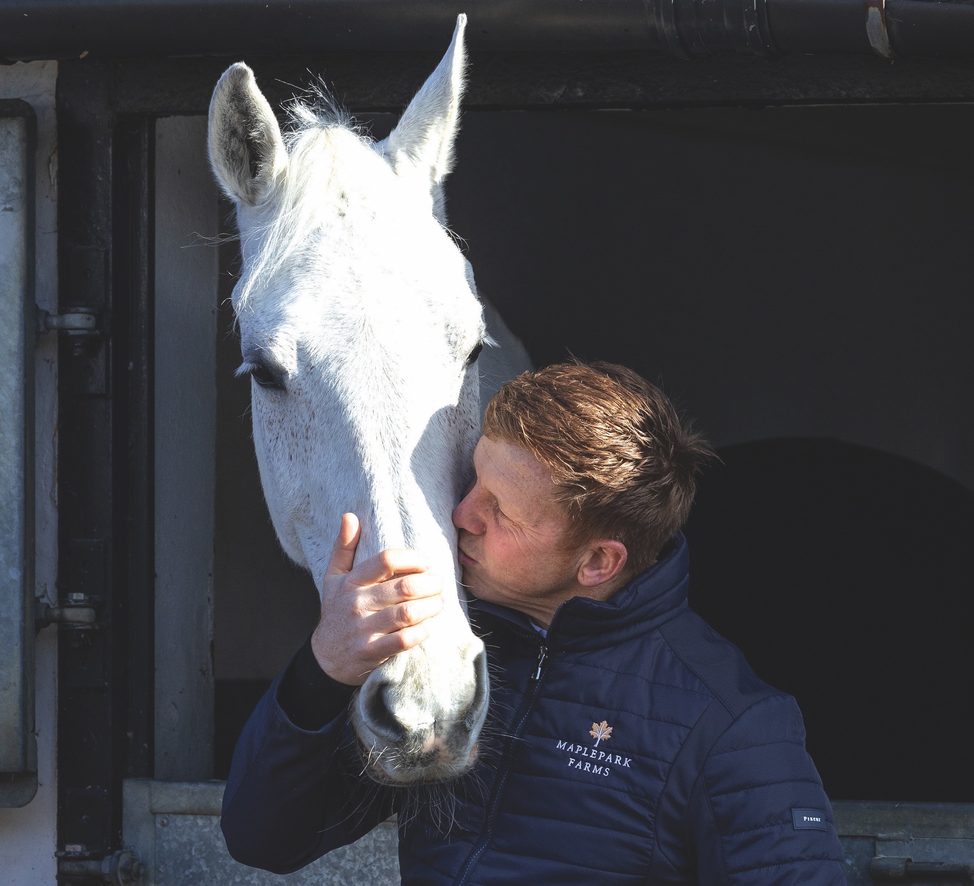 Matt Sampson kissing grey horse Ebolensky's head