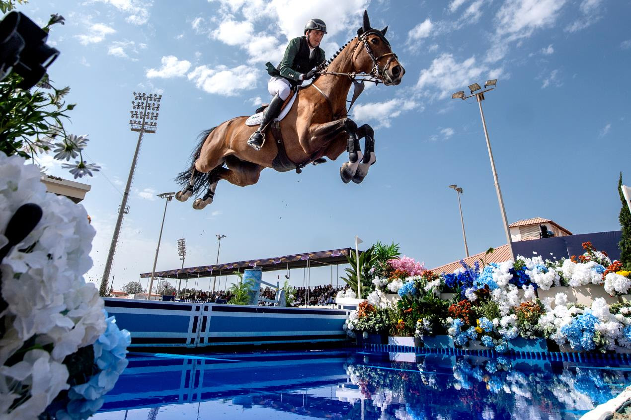 Trevor Breen and Highland President soar over the water jump in the Longines League of Nations LLN of Abu Dhabi in 2025, helping Ireland to victory.