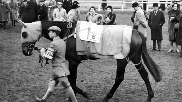 The Queen and Princess Elizabeth watching the Queen's horse Devon Loch paraded in the paddock at Hurst Park racecourse January 1952