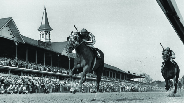 Secretariat winning the Kentucky Derby in front of packed stands in 1973.,