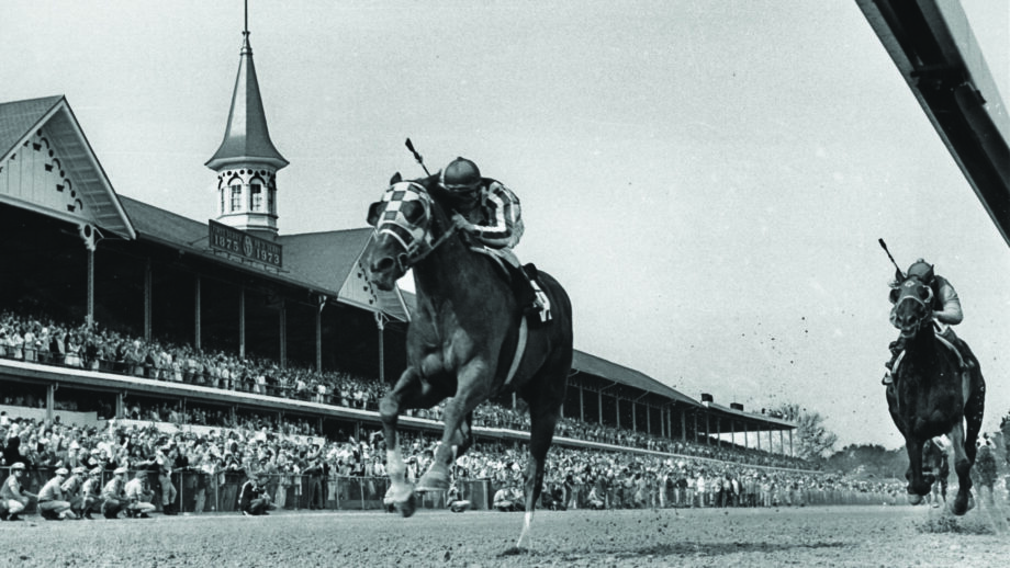 Secretariat winning the Kentucky Derby in front of packed stands in 1973.,