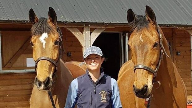 Flo Dawes of the Hawkstone Famers Choir, holding two horses