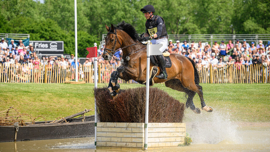 Christoph Wahler and D’Accord jump a fence in the water at Badminton Horse Trials 2025.
