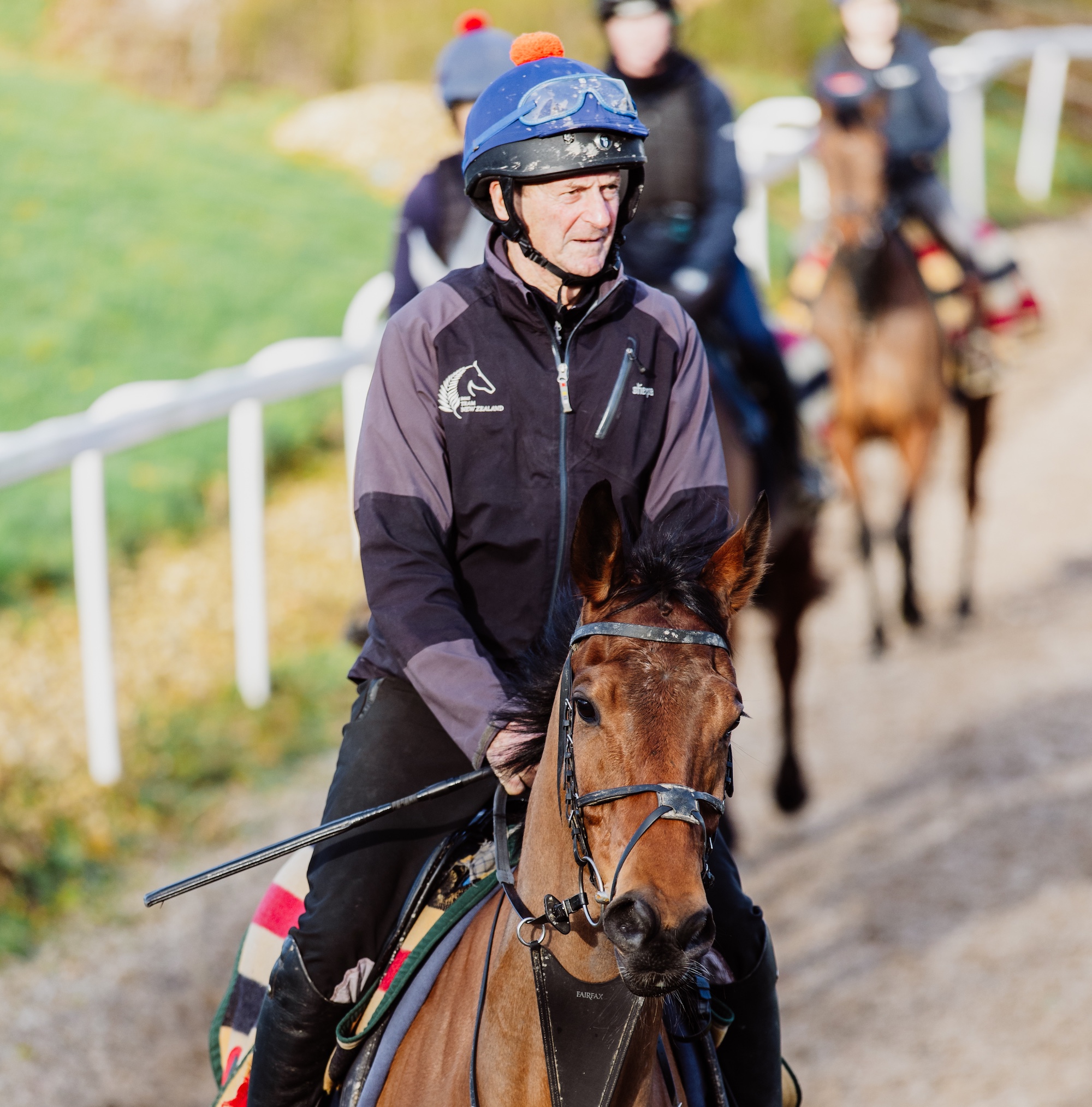Mark Todd riding a bay racehorse on gallops
