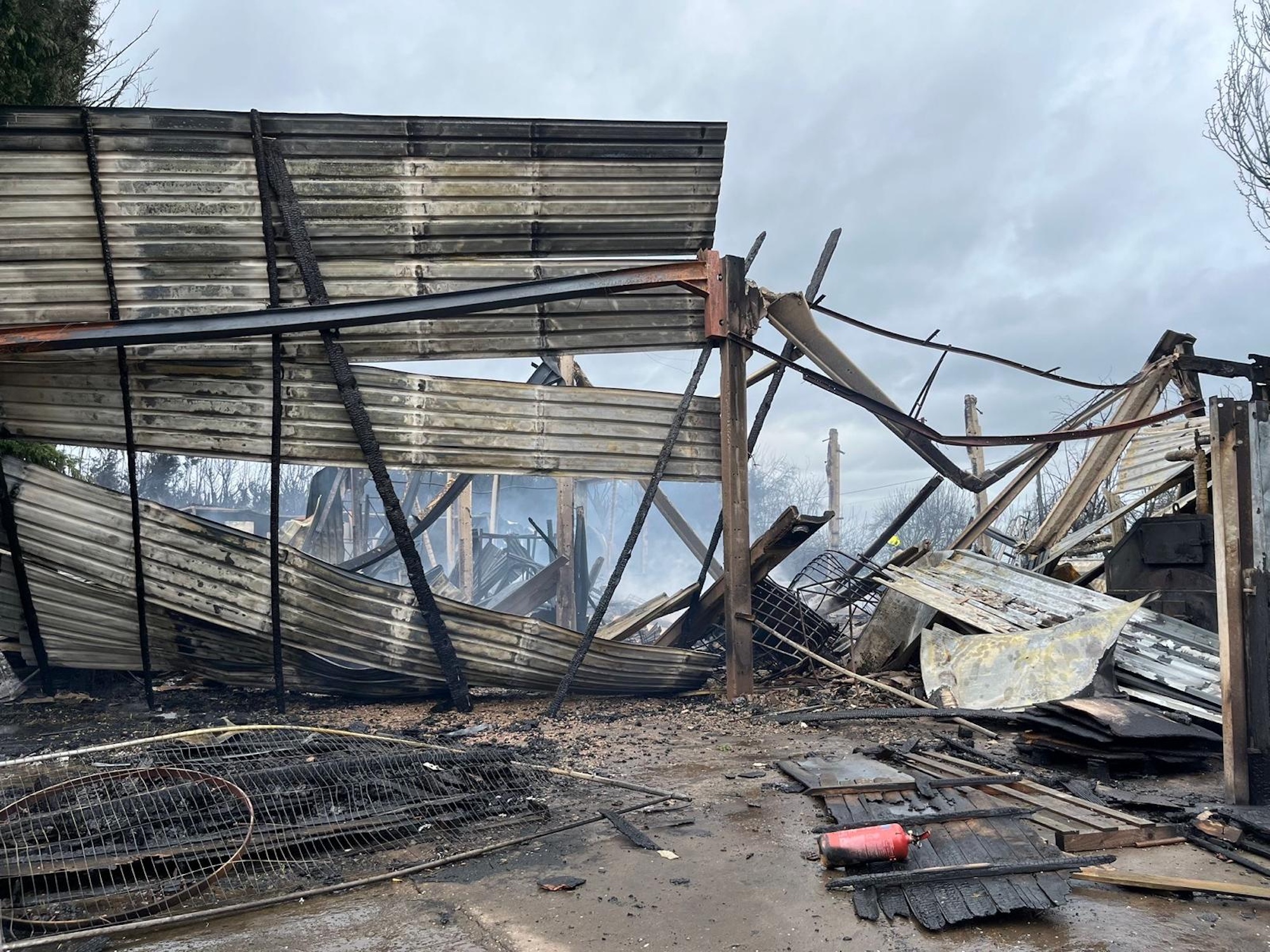 The remains of a burned building at Parallax Equestrian