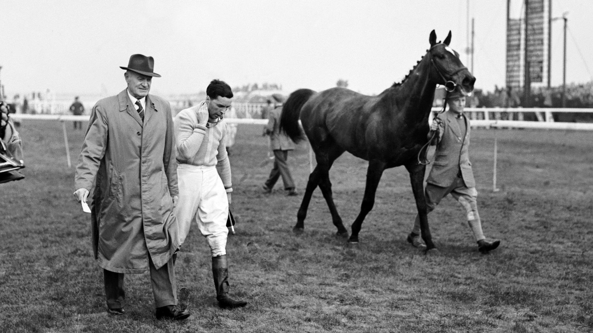 Dick Francis and Devon Loch are led away after the fall