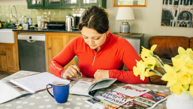 Female sat a table with her diary out planning the upcoming competition season