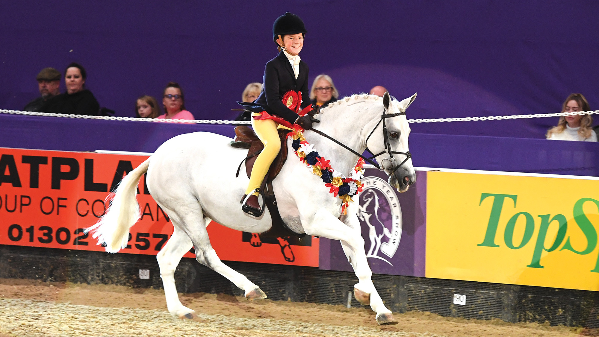 Noble Peppermint and Elsie Lynch enjoy their lap of honour at HOYS after being crowned working hunter pony champions