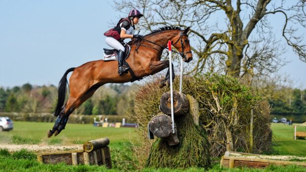 Image shows Sarah Bullimore and Reve Du Rouet jumping a cross-country fence at Aston-le-Walls in 2021.