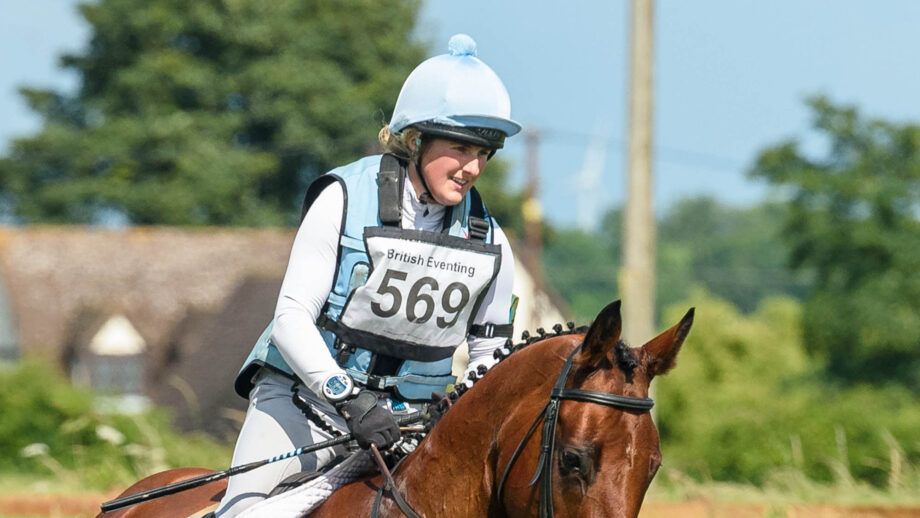 Image shows Sally Butler, pictured in 2021, wearing her pale blue cross-country colours and riding bay horse Diamonds Eclipse.