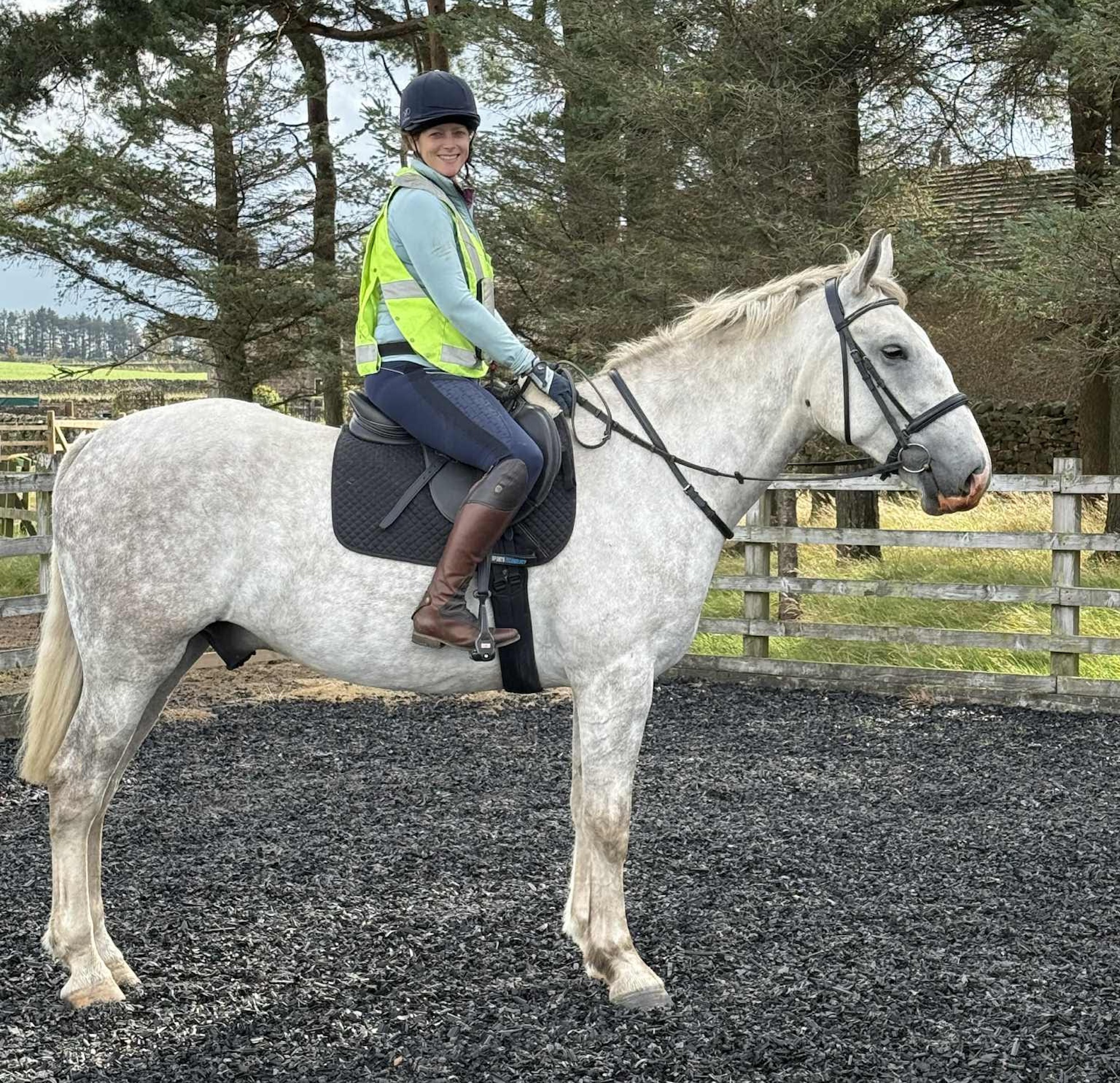 Emma riding Storm, wearing high-vis