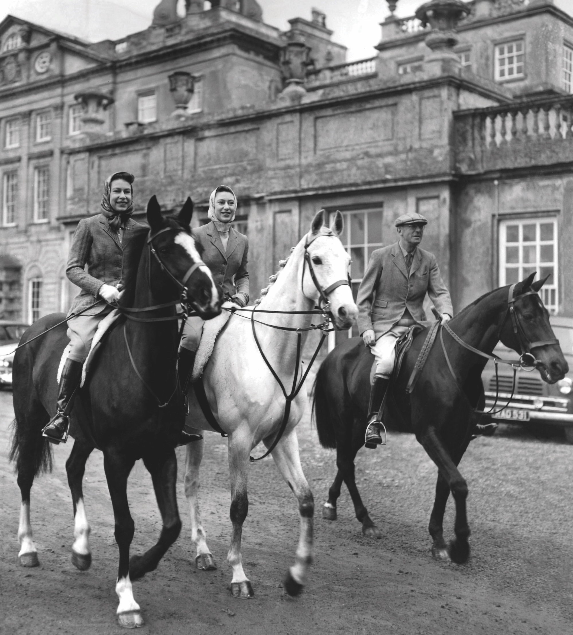 Queen Elizabeth II and Princess Margaret attending the Badminton Horse Trials. In the background is the home of the Duke of Beaufort, Badminton House where the Queen and Princess are taying during the three day international event at Badminton Park Gloucestershire 18th April 1959