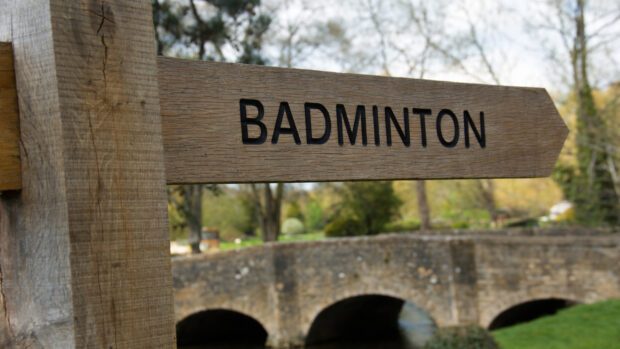 Wooden sign in village setting pointing to Badminton Horse Trials