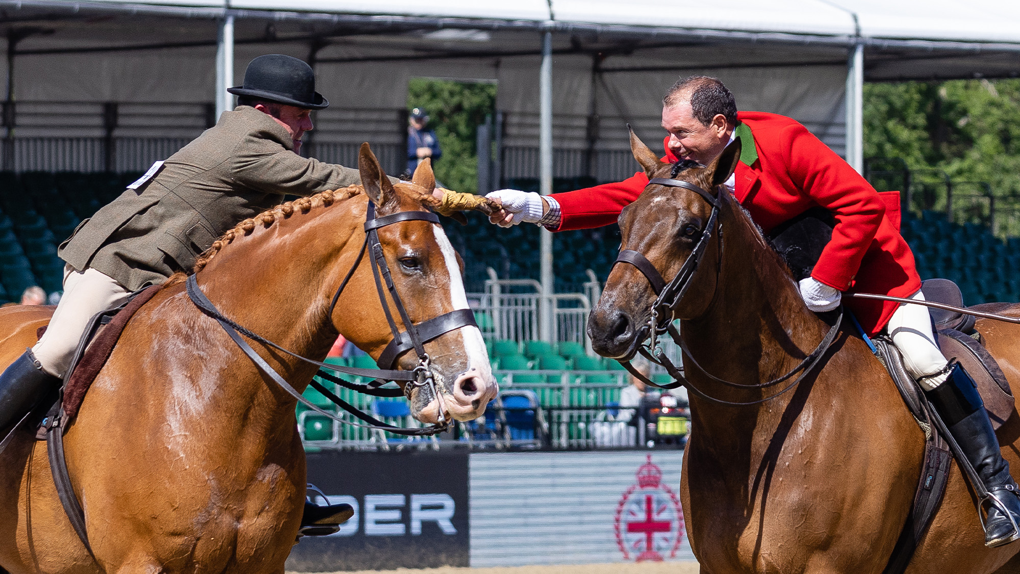 Champion Robert Walker congratulates second placed rider in the Hunter Championship at Royal Windsor