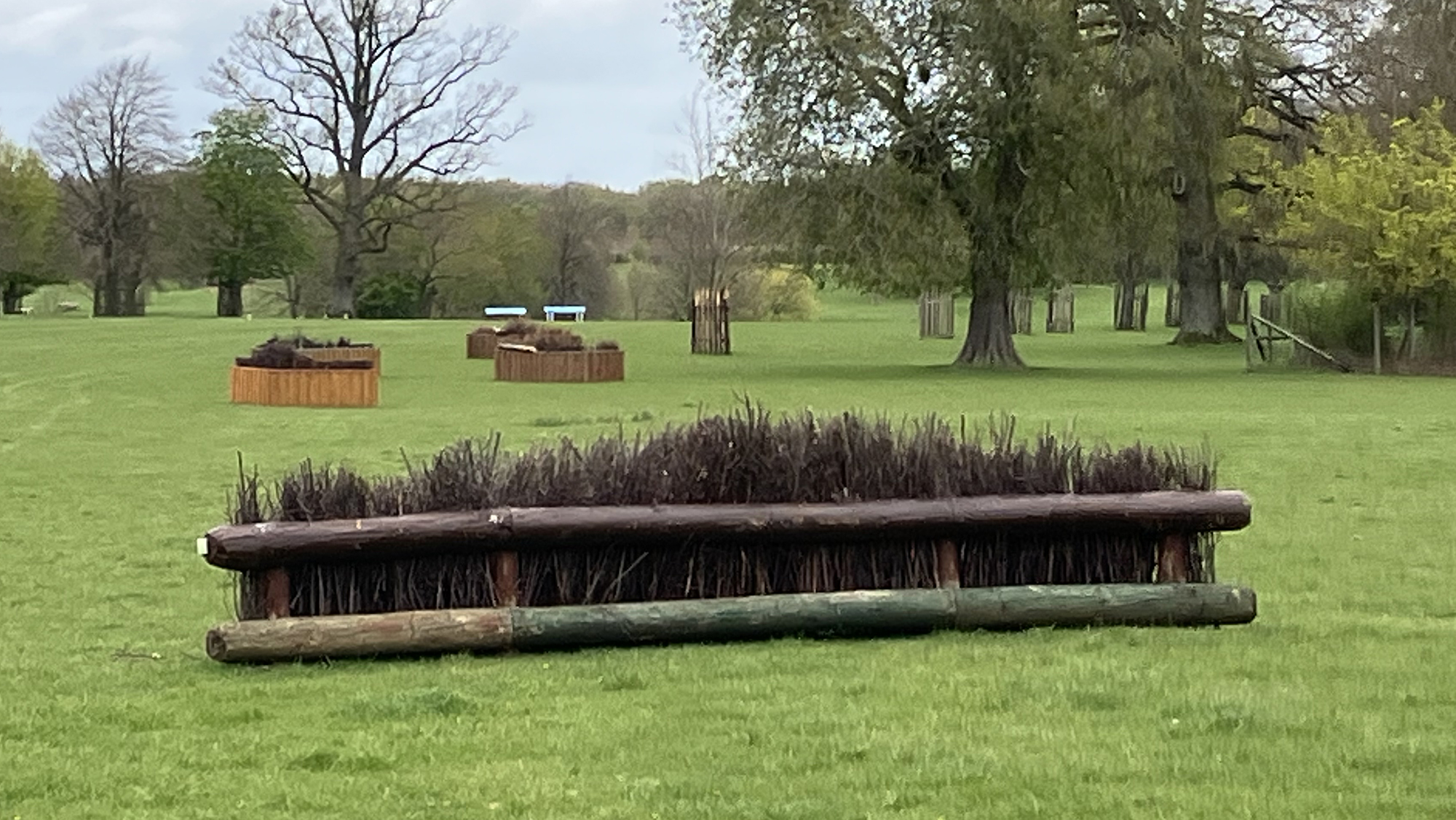 A brush "shooting butt" corner fence at Badminton grassroots with the next combination on course in the background