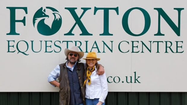 Julie and Brett Bevin by the Foxton Equestrian Centre sign