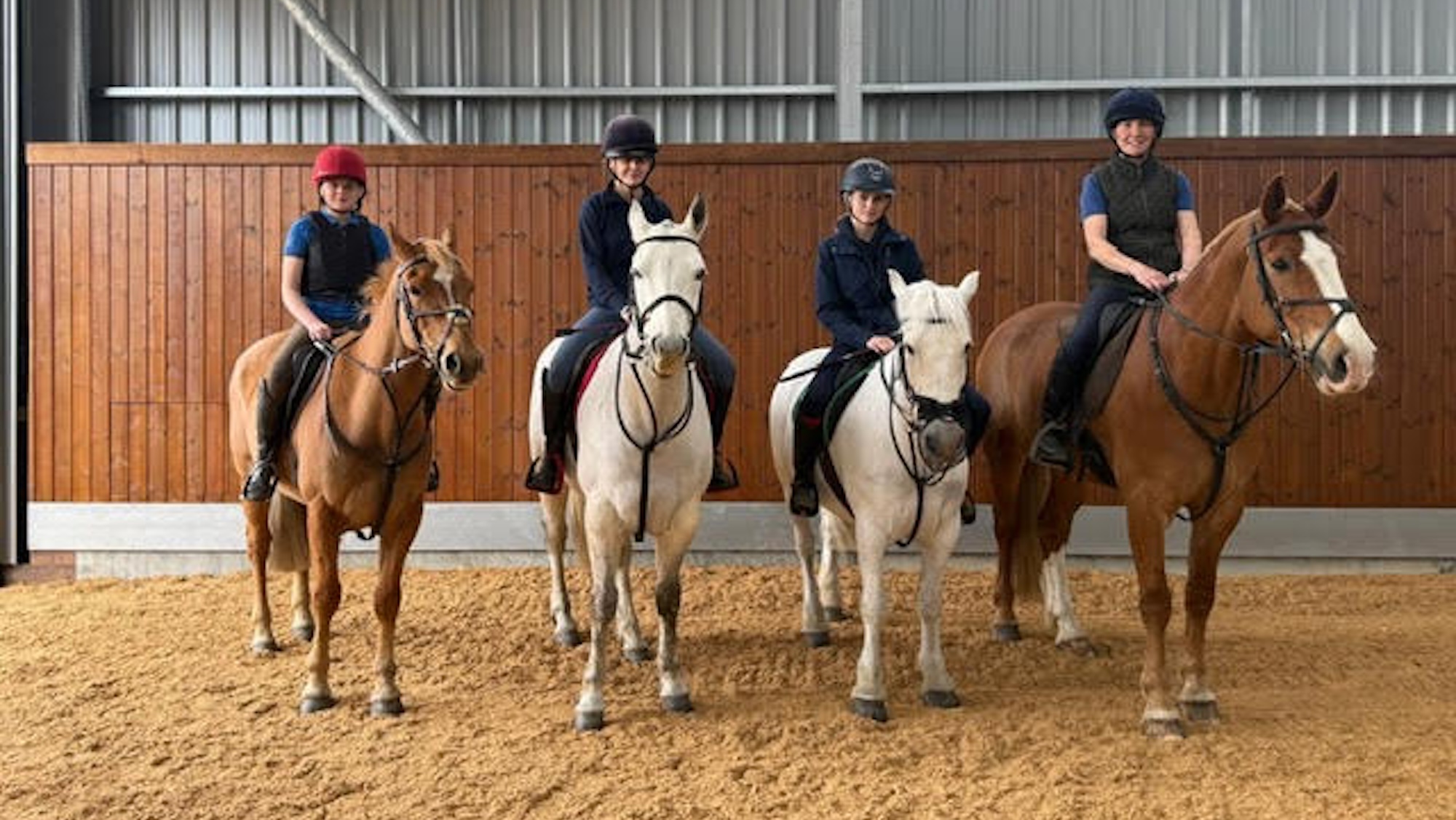 Julie Bevin and her three daughters, all on horses