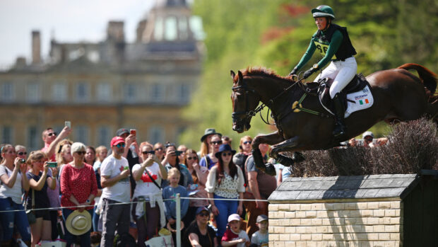Susie Berry riding across country at Badminton Horse Trials in front of a crowd