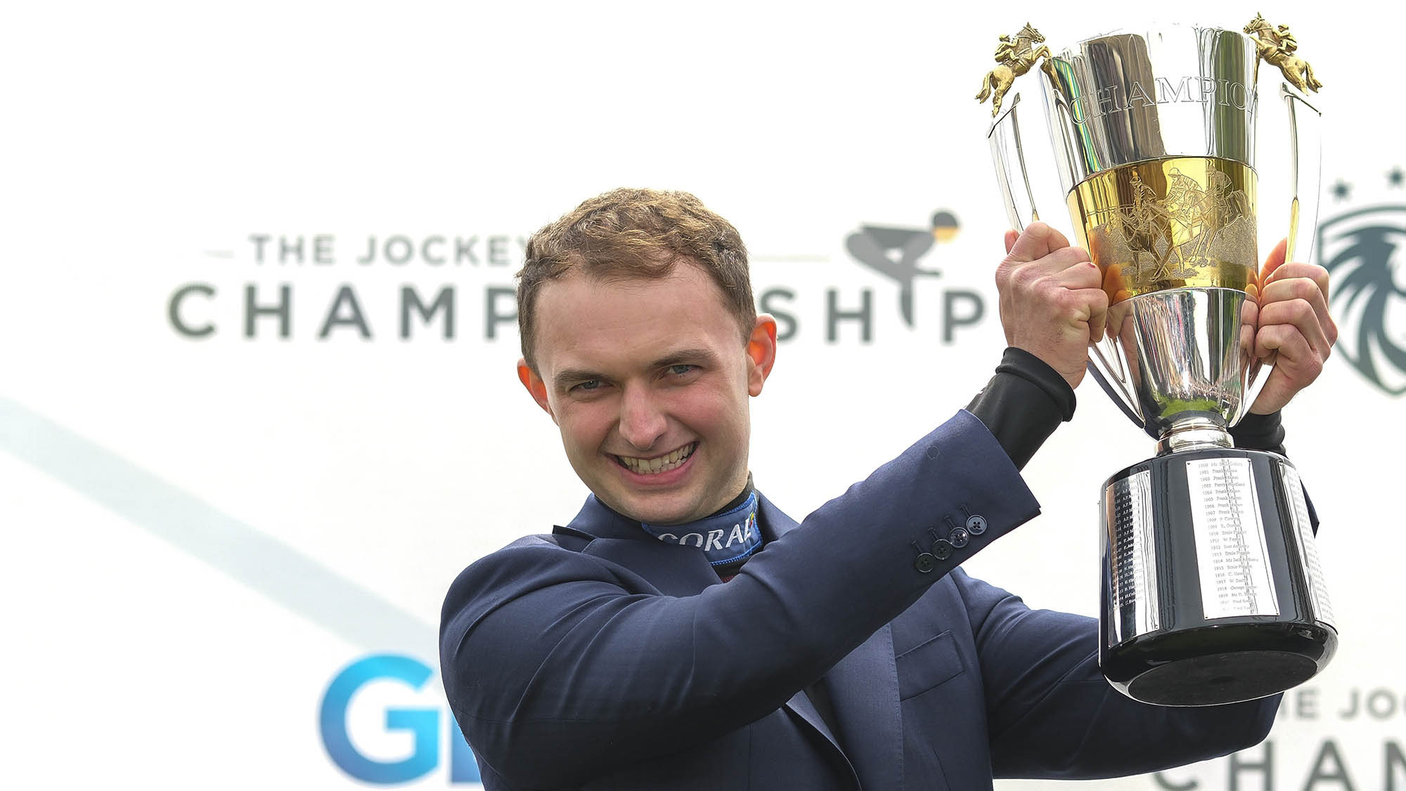 Jockey Sean Bowen with his trophy for becoming the 2024-25 Champion Jockey at Sandown Park Racecourse.