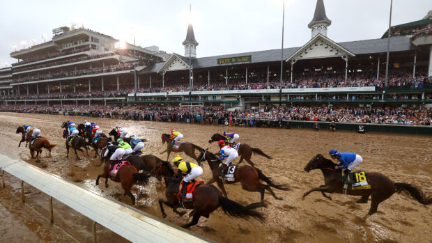 Riders and horses at the first turn of the Kentucky Derby