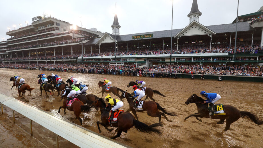 Riders and horses at the first turn of the Kentucky Derby