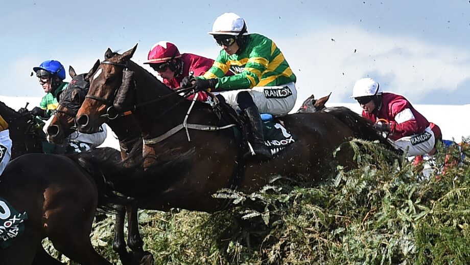 Jockey Paul Townend and I Am Maximus (C) jump The Chair on the way to winning the Grand National Handicap Chase on the final day of the Grand National Festival horse race meeting at Aintree Racecourse in Liverpool, north-west England on April 11, 2026. I Am Maximus became the first horse since Red Rum 49 years ago to regain his Grand National crown after he won a thrilling race at Aintree on Saturday. (Photo by PETER POWELL / AFP)