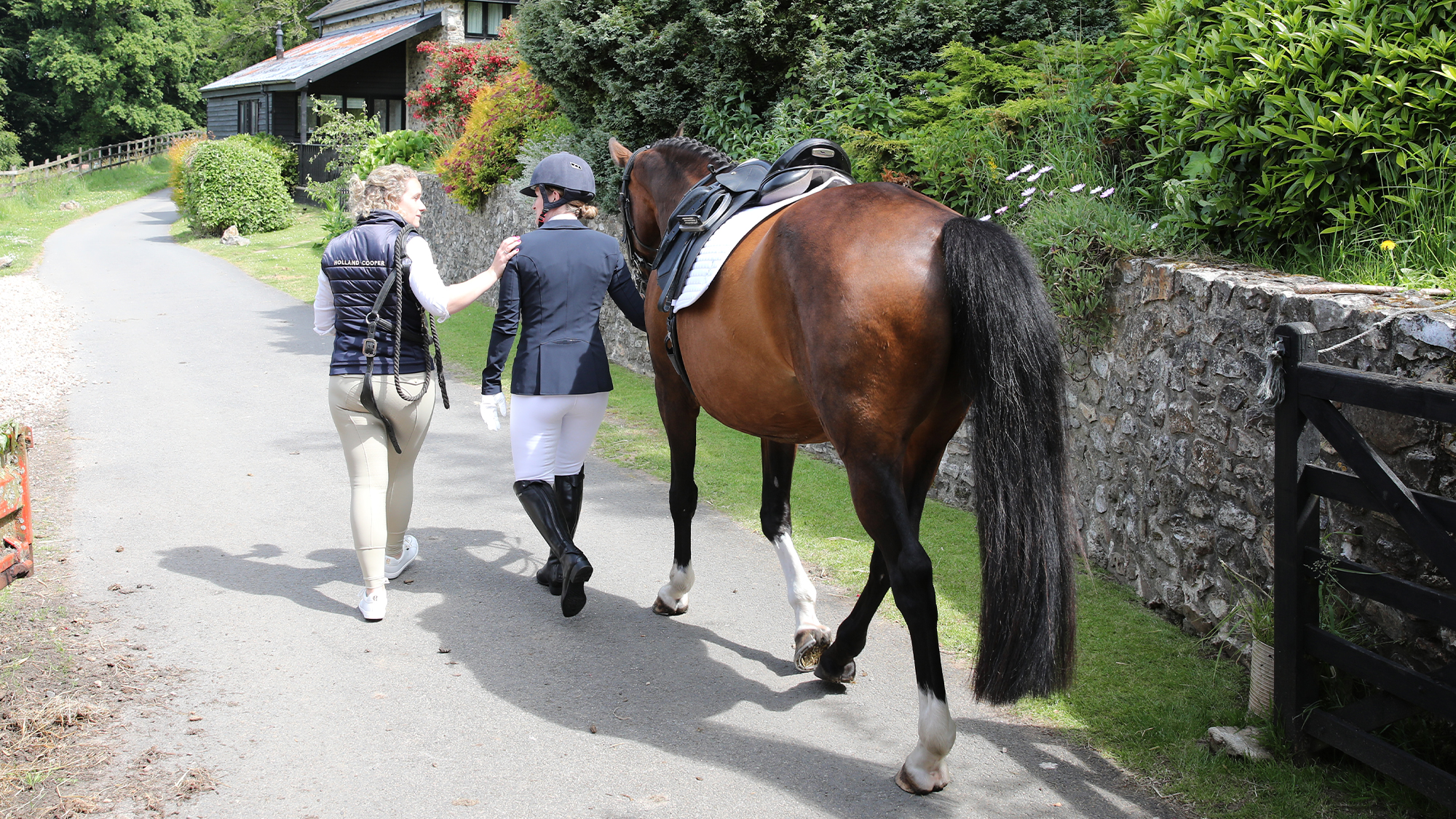Rider and friend walking horse back after fall