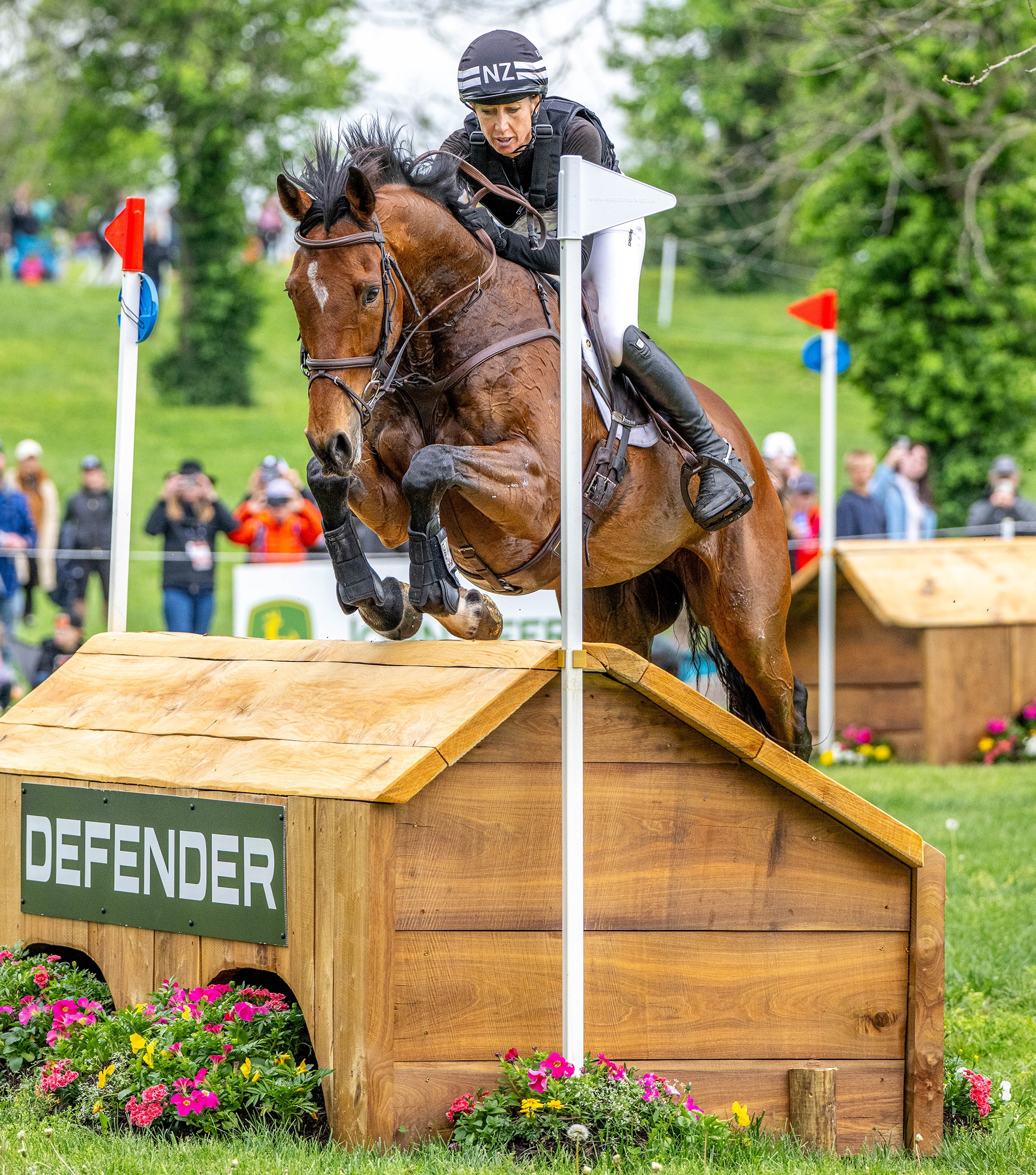 Monica Spencer and Artist jump a cross-country fence at an angle at Kentucky Three-Day Event 2025.