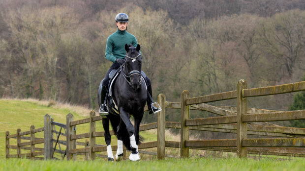 Justin riding his horse, Zonik Plus, through the fields at his home in Belgium.