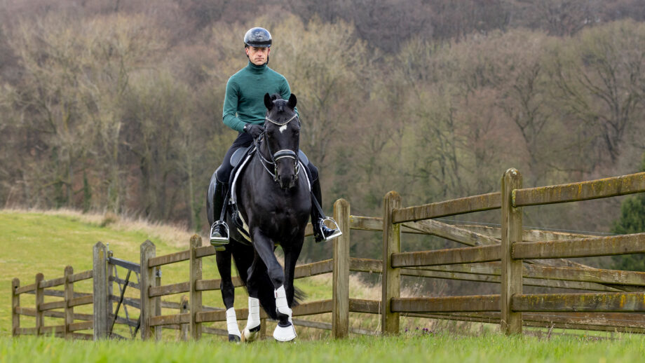 Justin riding his horse, Zonik Plus, through the fields at his home in Belgium.