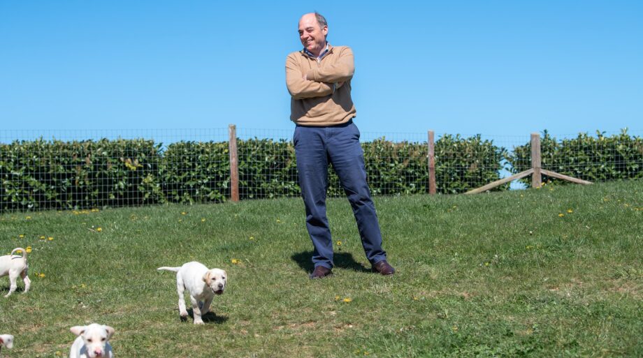 Ben Wallace watching hound puppies at hunt kennels