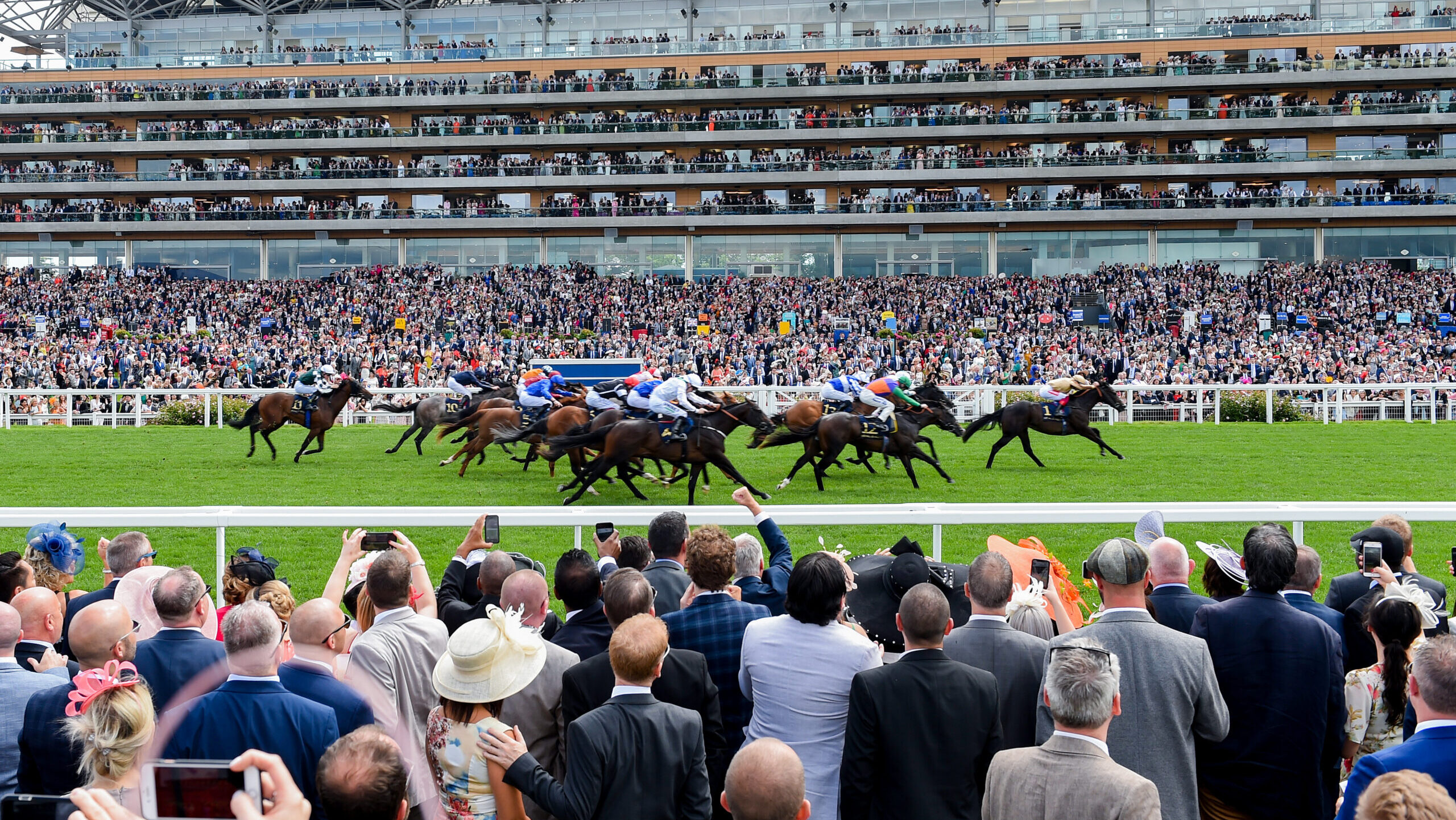 Racegoers watch the racing at Royal Ascot from the Village Enclosure in the centre of the track