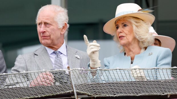 King Charles III and Queen Camilla watch their horse 'Treasure' run, and finish 11th, in the 'Oaks' as they attend 'Ladies Day' of the Betfred Derby Festival 2024 at Epsom Downs Racecourse on May 31, 2024 in Epsom, England. (Photo by Max Mumby/Indigo/Getty Images)