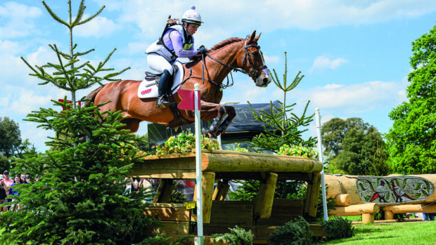 Gemma Stevens and Chilli Knight jump a cross-country fence at Badminton 2025.