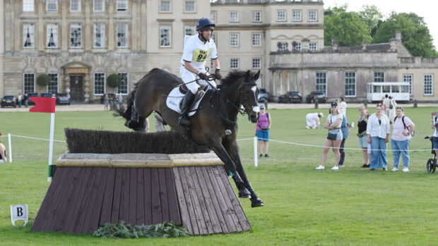 Harry Meade and Cavalier Crystal jump a cross-country fence at Badminton 2025.