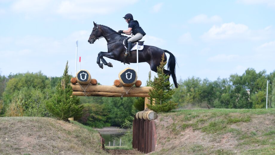 Katie Magee and Treworra jump a cross-country fence on their way to winning the 2025 British Open Championship.