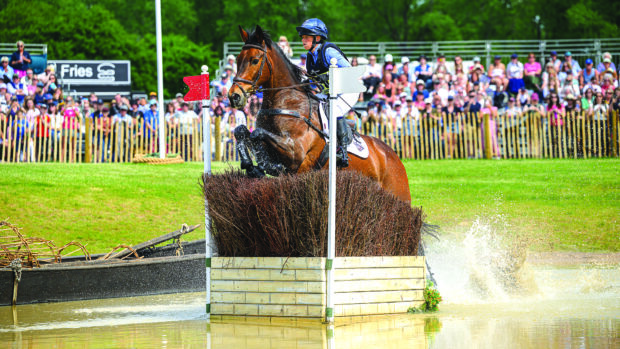 Ros Canter and Lordships Graffalo jump a cross-country fence in The Lake at Badminton 2025.