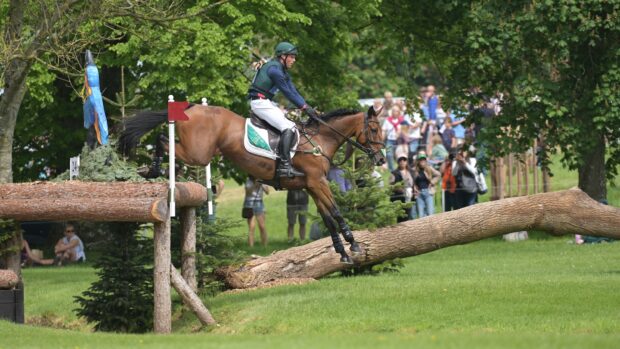 Sam Watson and Ballyneety Rocketman jump a cross-country fence at Badminton