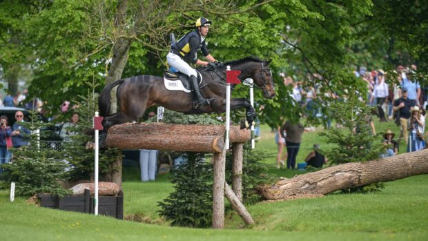 Will Rawlin and Ballycoog Breaker Boy jump a cross-country fence at Badminton Horse Trials 2026.