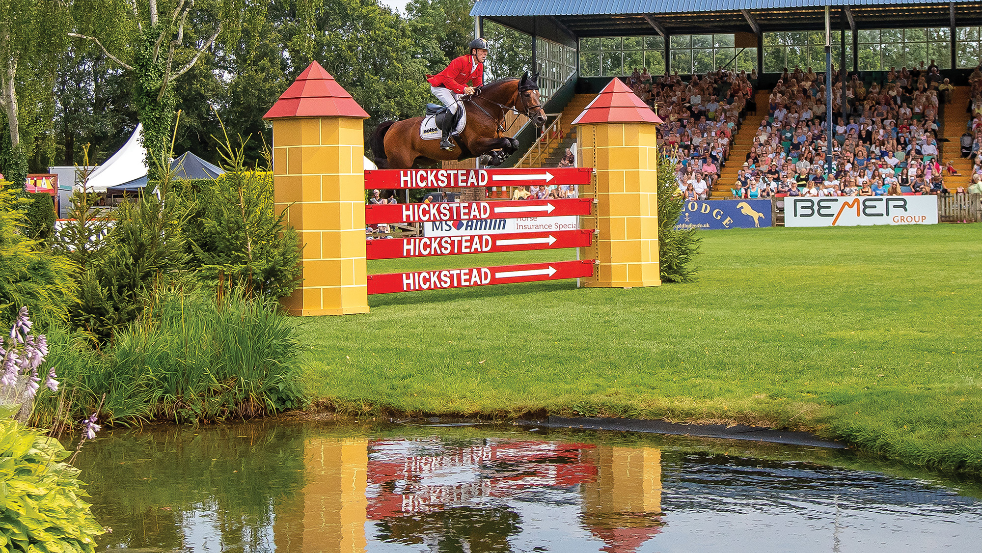 Rider jumping fence on the Hickstead course