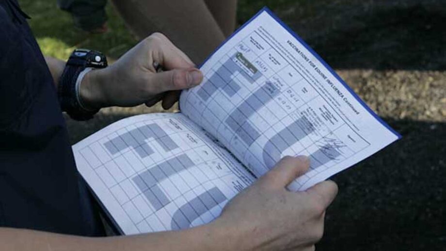Library image of a horse passport open at the flu vaccinations page