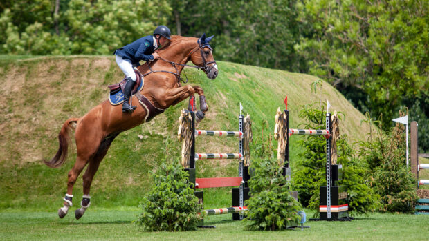 Shane Breen jumping Golden Hawk in front of the Hickstead Derby Bank