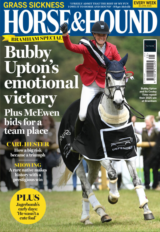 cover of Horse & Hound featuring Bubby Upton riding a grey horse, she wears a red jacket and the horse wears a navy Defender Bramham winner's rug
