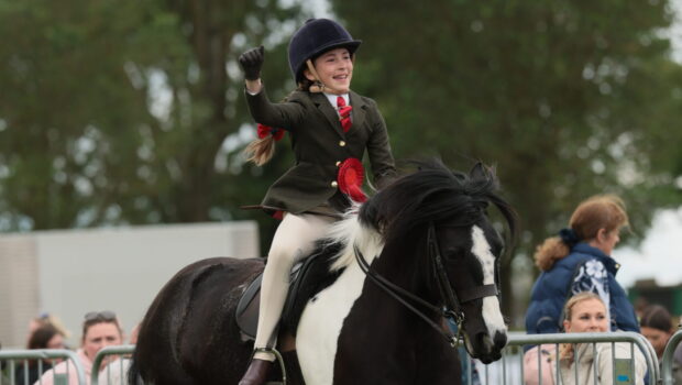 Matilda Mason punches the air as she and Flash Dance canter from the ring having won the Lincolnshire HOYS junior coloured qualifier