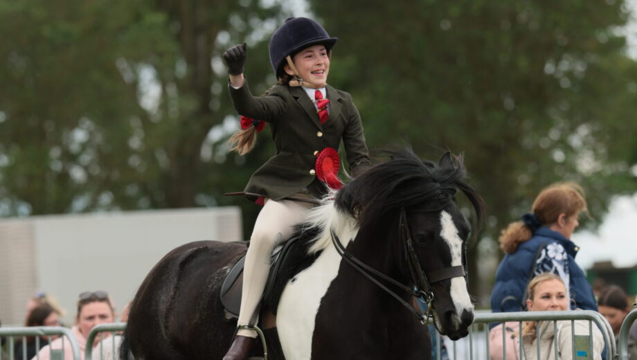 Matilda Mason punches the air as she and Flash Dance canter from the ring having won the Lincolnshire HOYS junior coloured qualifier
