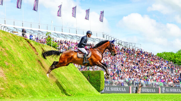 Flamboyant III jumps dramatically off the side of the hickstead Derby bank